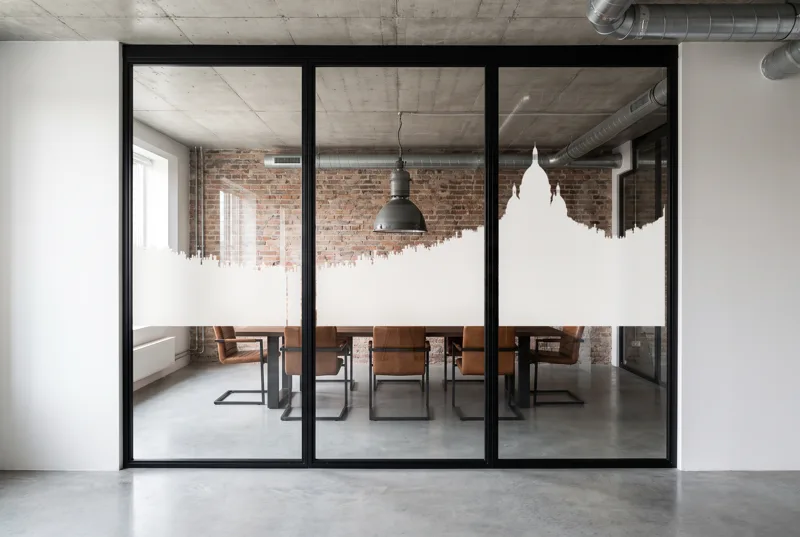 Simulation : vitrophanie Horizon Montmartre en film blanc sur une salle de réunion de loft en brique, bande de 118 cm à l'échelle